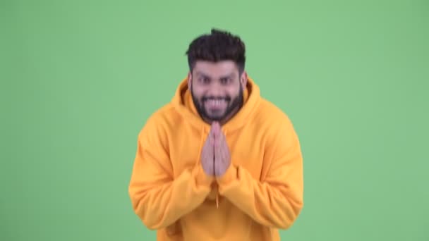 Happy young overweight bearded Indian man bowing with respect — Stock Video