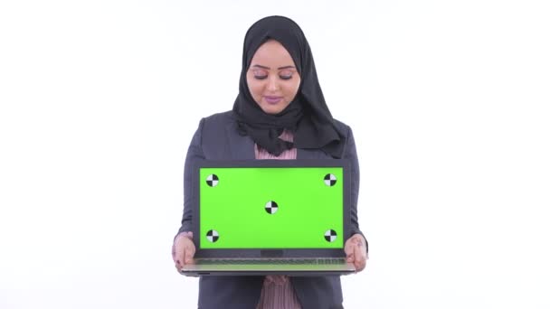 Happy young African Muslim businesswoman thinking while showing laptop — Stock Video