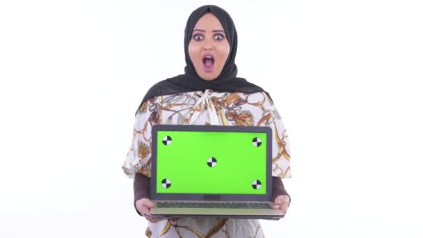 Happy young African Muslim woman showing laptop and looking surprised — Stock Video