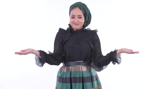 Confused young African Muslim woman shrugging shoulders — Stock Video