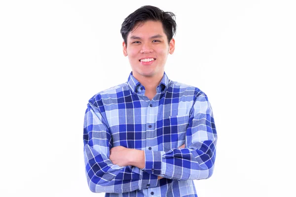 Happy young handsome Asian hipster man smiling with arms crossed — Stock Photo, Image