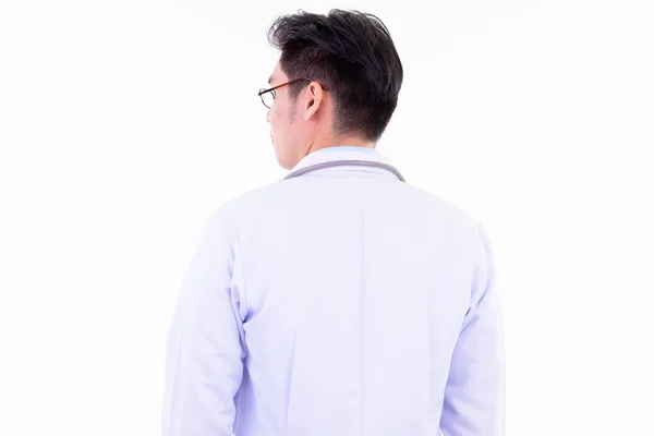 Rear view of young Asian man doctor looking over shoulder — Stock Photo, Image