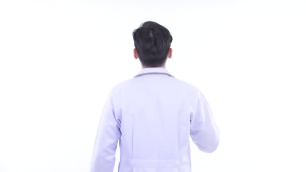 Vista posteriore del giovane asiatico uomo medico toccare qualcosa — Video Stock