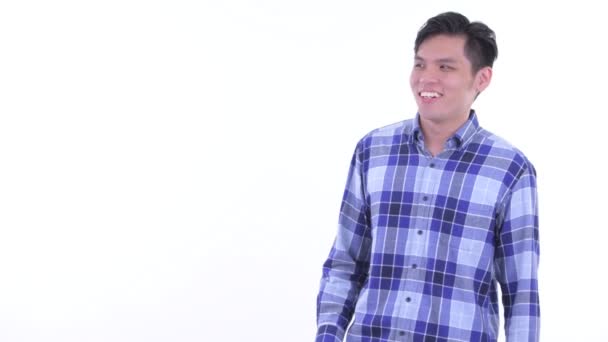 Boldog fiatal ázsiai csípő ember megható valamit, ami remek — Stock videók