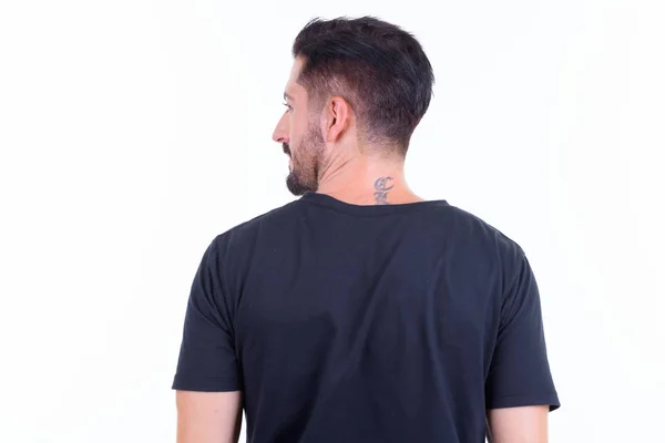 Achteraanzicht van jonge bebaarde man met uitzicht op schouder — Stockfoto