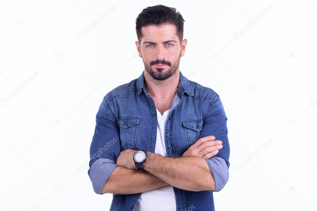 Young handsome bearded hipster man with arms crossed