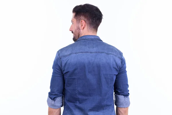 Rear view of young bearded hipster man looking over shoulder — Stock Photo, Image
