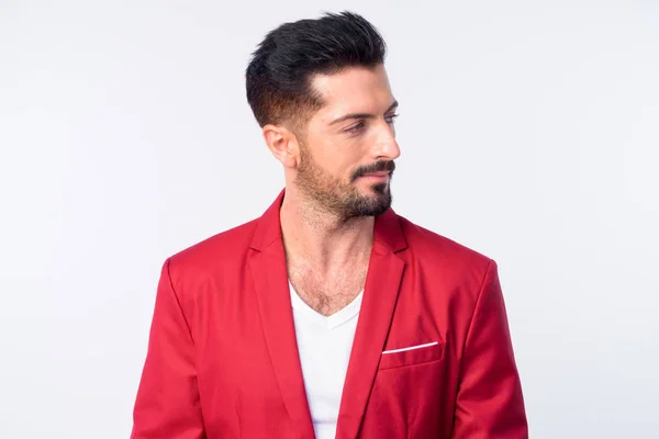 Face of young handsome bearded businessman in red suit — Stock Photo, Image