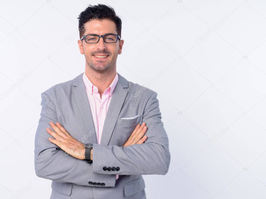 Happy young businessman wearing eyeglasses with arms crossed