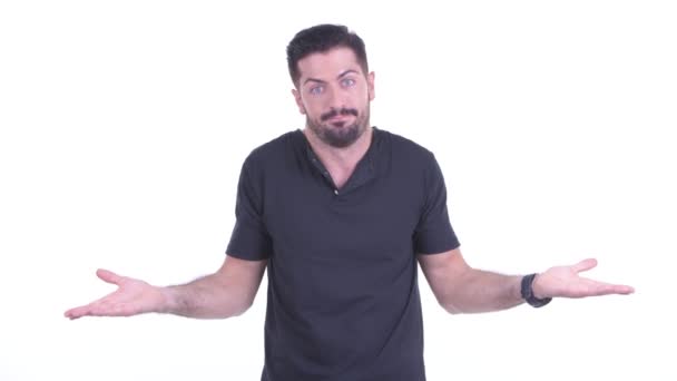 Confused young handsome bearded man shrugging shoulders — Stock Video