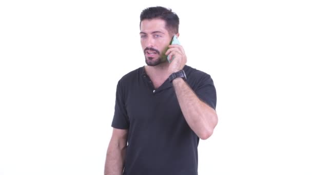 Happy young handsome bearded man talking on the phone — Stock Video