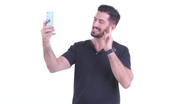 Happy young handsome bearded man taking selfie — Stock Video