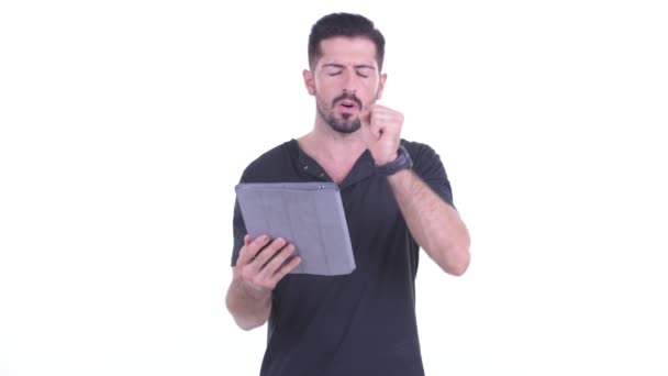 Stressed young bearded man using digital tablet and getting bad news — Stock Video