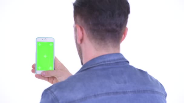 Closeup rear view of young bearded hipster man using phone — Stock Video