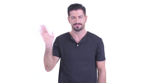 Happy young handsome bearded man waving hands — Stock Video