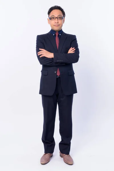 Full body shot of Japanese businessman in suit with arms crossed — Stock Photo, Image