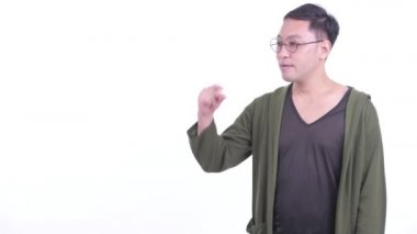 Happy Japanese man with eyeglasses snapping fingers and giving thumbs up