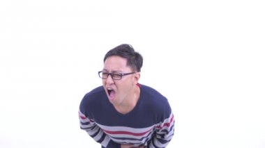 Stressed Japanese hipster man with eyeglasses having stomachache