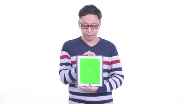 Stressed Japanese hipster man showing digital tablet and getting bad news — 图库视频影像