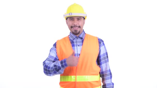 Счастливый бородатый персидский строитель, показывающий большие пальцы — стоковое видео