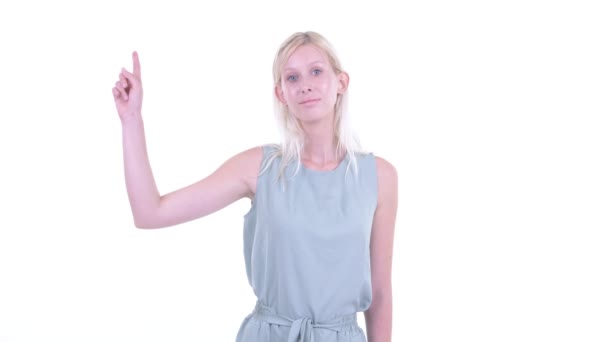 Happy young beautiful blonde woman pointing up — Stock Video