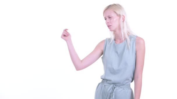 Stressed young blonde woman snapping fingers and giving thumbs down — Stock Video