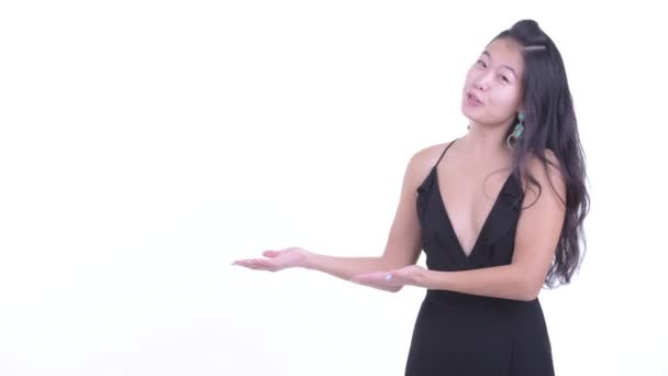 뭔가를 보여주는 동안 말하는 행복한 아름다운 아시아 여자 — 비디오
