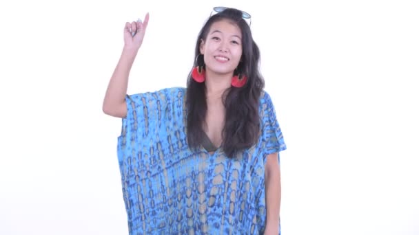 Happy beautiful Asian tourist woman pointing up — Stock Video