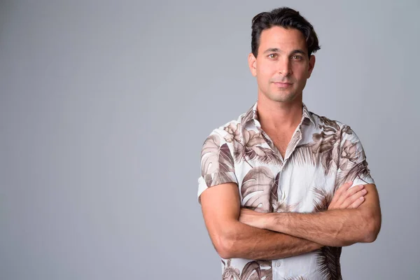 Portrait of handsome Hispanic tourist man with arms crossed — Stock Photo, Image