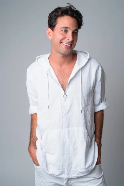 Portrait of happy handsome Hispanic man thinking and looking away — Stock Photo, Image