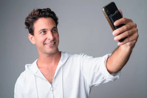 Face of happy handsome Hispanic man taking selfie — Stock Photo, Image