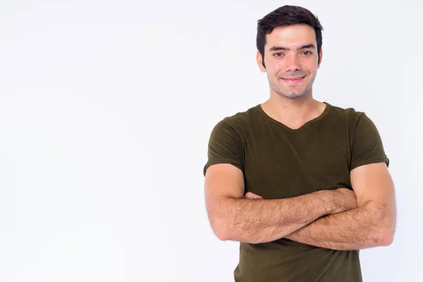 Retrato de joven feliz guapo persa sonriendo con los brazos cruzados —  Fotos de Stock