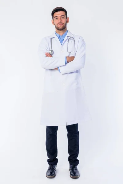 Full body shot of young bearded Persian man doctor with arms crossed — Stock Photo, Image