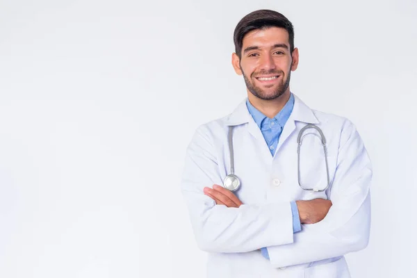 Portrait of happy young bearded Persian man doctor smiled with arms crossed — Stok Foto