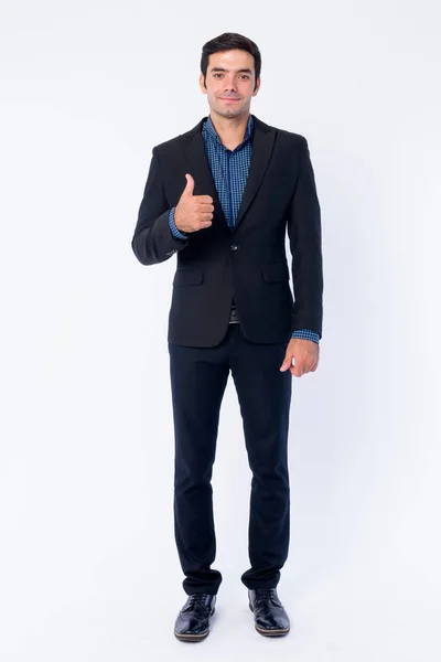 Full body shot of happy young handsome Persian businessman giving thumbs up — Stock Photo, Image