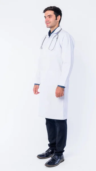 Full body shot of young Persian man doctor thinking — Stock Photo, Image