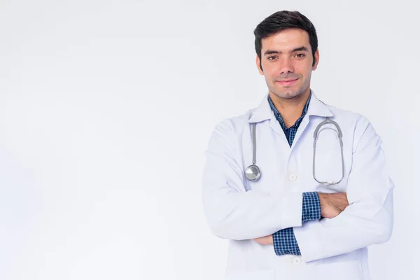 Portrait of happy young Persian man doctor smiling with arms crossed — Stock Photo, Image