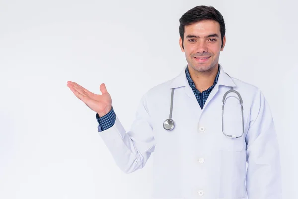 Portrait of happy young Persian man doctor showing something — Stock Photo, Image