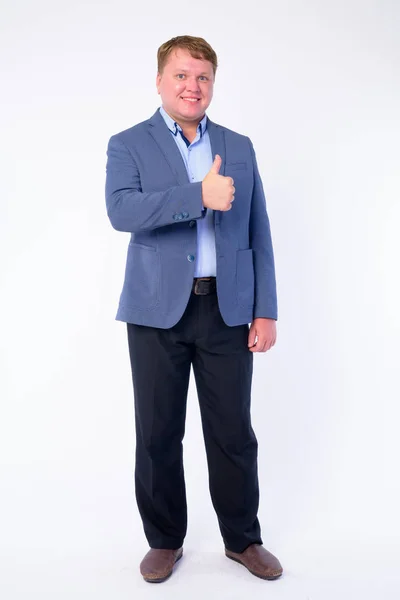 Full body shot of happy overweight businessman in suit giving thumbs up — Stock Photo, Image