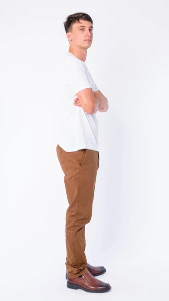 Full body shot profile view of young handsome man looking at camera — Stock Photo, Image