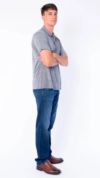 Full body shot profile view of young handsome man looking at camera — Stock Photo, Image