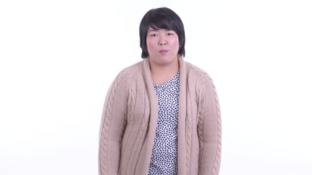 Happy overweight Asian woman getting good news ready for winter — Stock Video