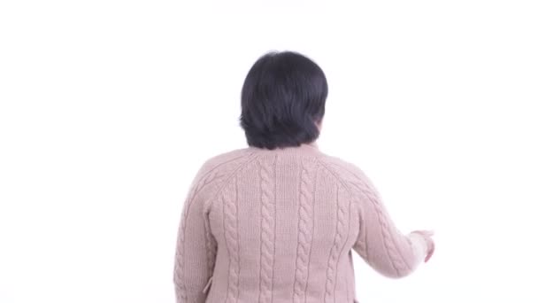 Bakifrån av överviktig asiatisk kvinna vidröra något och redo för vintern — Stockvideo