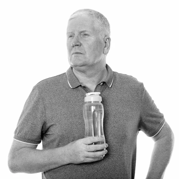 Stüdyo çekim olgun adam su şişesi düşünürken holding — Stok fotoğraf