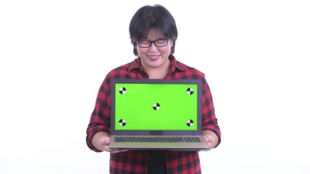 Happy overweight Asian hipster woman thinking while showing laptop — Stock Video