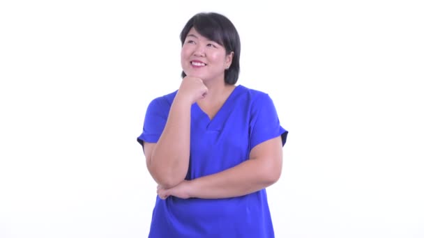 Happy overweight Asian businesswoman thinking and looking up — Stock Video