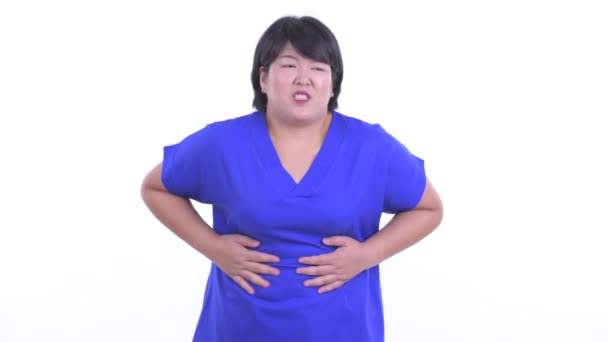 Stressed overweight Asian businesswoman having stomachache — Stock Video