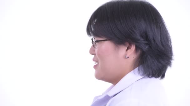 Closeup profile view of happy overweight Asian woman doctor talking — Stock Video