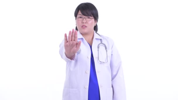 Serious overweight Asian woman doctor with stop gesture — Stock Video