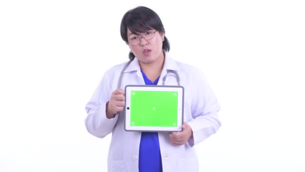 Heureux en surpoids asiatique femme médecin parler tout en montrant tablette numérique — Video